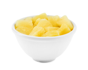 Fototapeta na wymiar Bowl with pieces of delicious sweet canned pineapple on white background