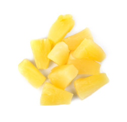 Pieces of delicious sweet canned pineapple on white background, top view