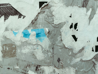 Vintage old posters sticked and torn on wall for your grunge background