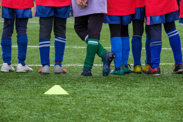 football school students in old uniforms and old boots are on an artificial field one of them crossed his