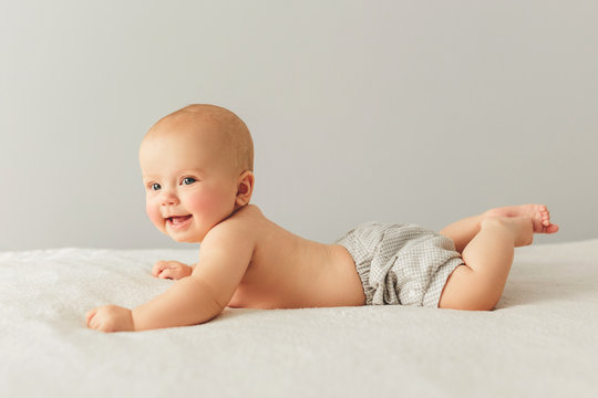 Portrait of a cute 3 months baby lying down on a blanket