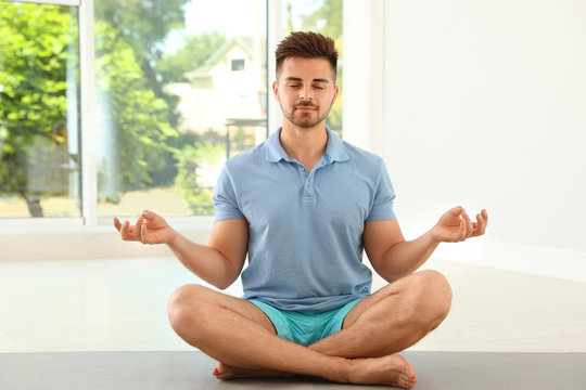 Handsome Young Man Practicing Zen Yoga Indoors