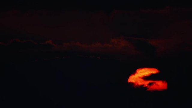 Red sunset in black clouds, contrasting sky