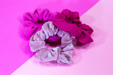 Three Pink Scrunchies Multi Color and Texture on Two Tone Pink Background
