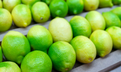 Ripe green lemons. Harvest of autumn in the store.