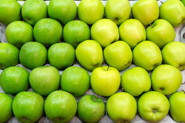 Ripe green apples. Harvest of autumn in the store.