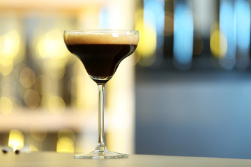 Fresh alcoholic Martini Espresso cocktail on bar counter, space for text