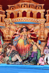 Obraz premium Goddess Durga idol at decorated Durga Puja pandal, shot at colored light, at Kolkata, West Bengal, India. Durga Puja is biggest religious festival of Hinduism and is now celebrated worldwide.