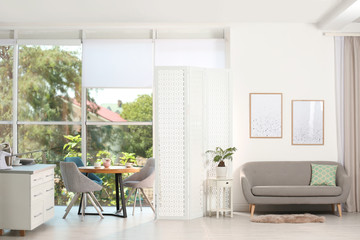 Modern folding screen in stylish room interior