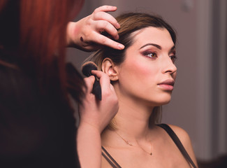 Obraz premium Makeup artist does makeup and creates an image for models
