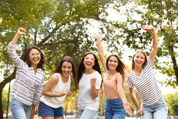 Happy women outdoors on sunny day. Girl power concept
