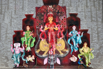 Goddess Durga idol at decorated Durga Puja pandal, shot at colored light, at Kolkata, West Bengal,...