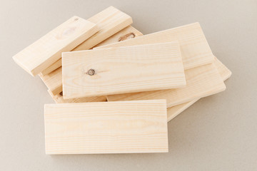 Stack of small planks on grey background.