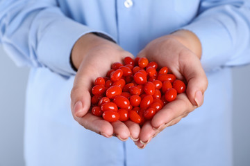 Woman holding fresh goji berries, closeup view