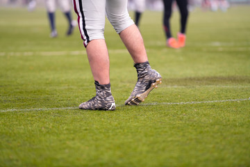 close up of american football players stretching and warming up