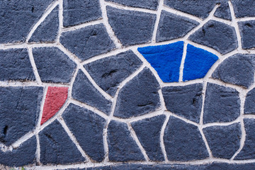 Texture on the wall in the form of a mosaic with colored cells