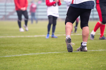 close up of american football players stretching and warming up