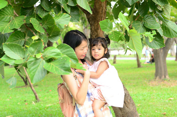 Little Child Girl and Mother at The Public Park