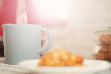 Cup of tea or coffee on modern kitchen background
