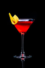 Cosmopolitan classic cocktail with reflection on a dark background