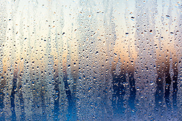 A foggy window at sunset as an abstract background - obrazy, fototapety, plakaty