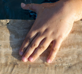 Hand of a boy in the pool