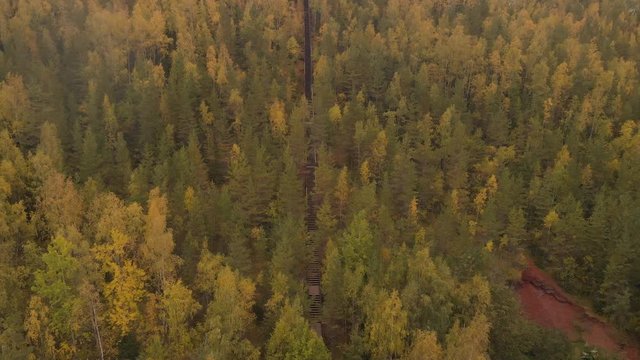 Aerial footage of drone flying upwoards a staircase on a hill.