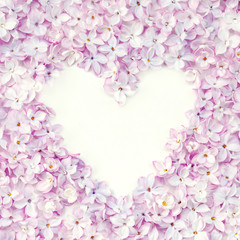 Obraz na płótnie Canvas Lilac flowerheads heart shape frame. Floral beautiful border with copyspace.