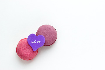 French Pink Macaroons on White Background. Top View Traditional Dessert for Feminine Design. Confectionery, Fashion, Beauty Advertising Template.