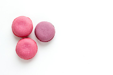 French Pink Macaroons on White Background. Top View Traditional Dessert for Feminine Design. Confectionery, Fashion, Beauty Advertising Template.