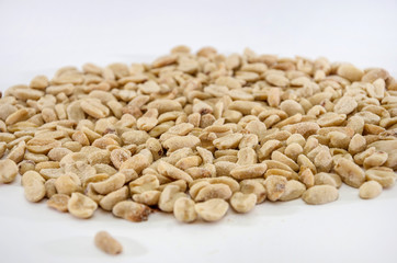 salted peanuts on a white background. Close-up.