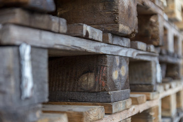 Fototapeta na wymiar Close up of wooden cargo pallets overlap in warehouse. Selectiive focus.