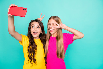Photo of two excited blinking blonde brunette trendy model people girls recording video calling...