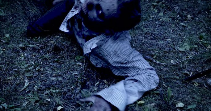 Zombie climbs out of the grave in the night cemetery. Halloween. Horror.