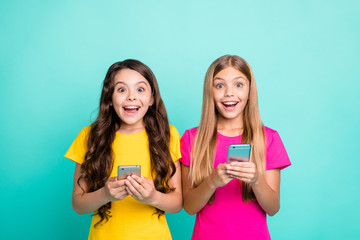 Photo of two fashionable trendy enjoying happy crazy encouraged people wearing yellow pink t-shirts...