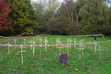 Fake cemetery in a park in Ghent, Begium, with crosses and tombs to celebrate Halloween