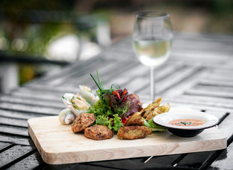 mixed asian seafood snacks platter on restaurant table