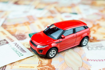 Toy car on money