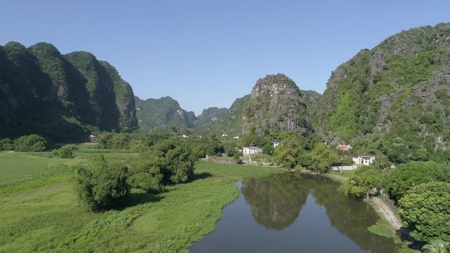 Stock 4k: Trang An rowboats cave tours on river and beautiful mountains view, Ninh Binh, Vietnam. Trang An is UNESCO World Heritage Site, famous places in Vietnam, one of the most popular destinations