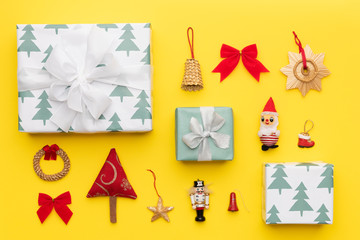 Wrapped christmas gifts and many retro christmas ornaments isolated on bright yellow background. Christmas composition.