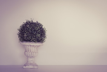 Fake tree on table in room,with copy space.