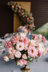 The beautiful, wedding bouquet on the holiday table adorns the table for guests