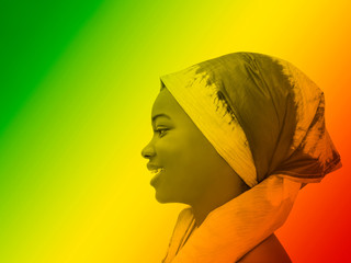 Green, yellow and red portrait of a smiling girl wearing a headscarf, profile view 