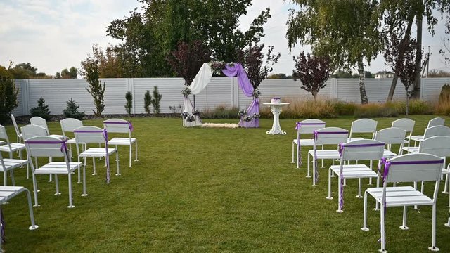 Wedding ceremony decoration on wind. Wind blows colorful ribbons in spring sunlight