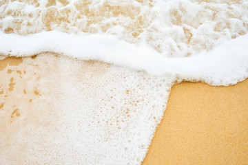 close up white bubble wave on brown sand,foam wave on the beach,