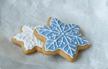 Christmas gingerbread in the form of a snowflake on a paper background