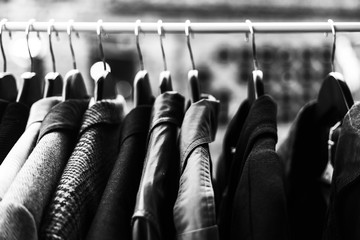 Clothes on the hangers at the flea market, low prices clothing concept, black and white