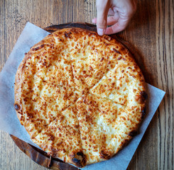 Traditional Georgian Khachapuri Cheese Pie, on wooden table, top view