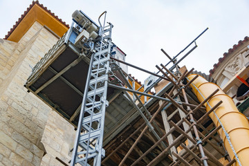 Scaffolding with a sleeve for dumping construction waste on the reconstruction of the ancient cathedral