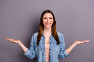 Portrait of positive cheerful lady promoter hold hand recommend adverts sales discounts wear denim jeans clothes isolated over grey color background